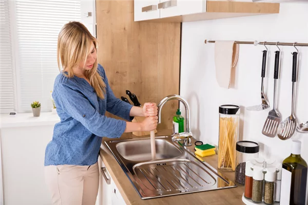 Woman Plunging Sink All Service Plumbing