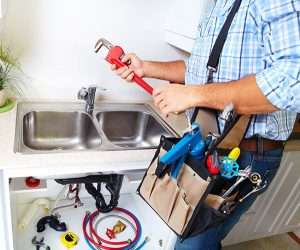 plumber repairing kitchen sink close up