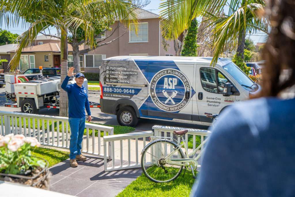 All Service Plumber Employee Waving to Customer