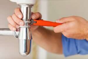picture of professional plumbing service repairman repairing a sink