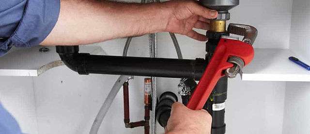 professional plumber performing residential plumbing service